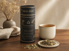 Milky Wave Lactation Tea canister with a cup of tea and tea leaves on a wooden table.