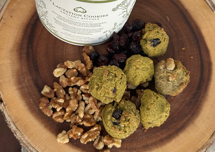 The Milky Wave lactation cookies with walnuts and cranberries on a wooden serving board